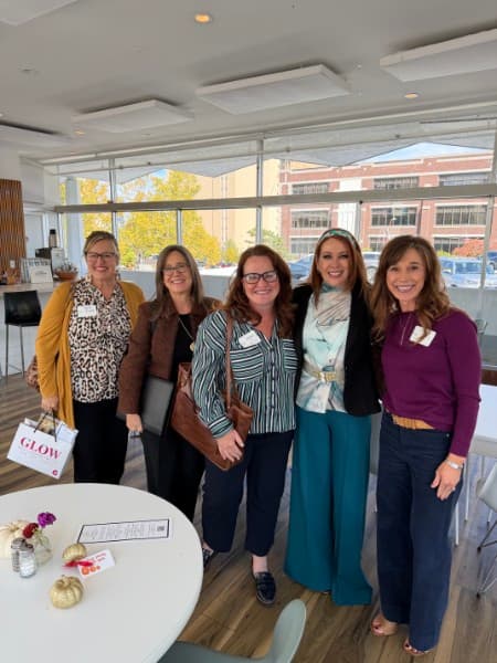Jenny Guthrie with four guests at The Vault, one holding a Glow Medical gift bag