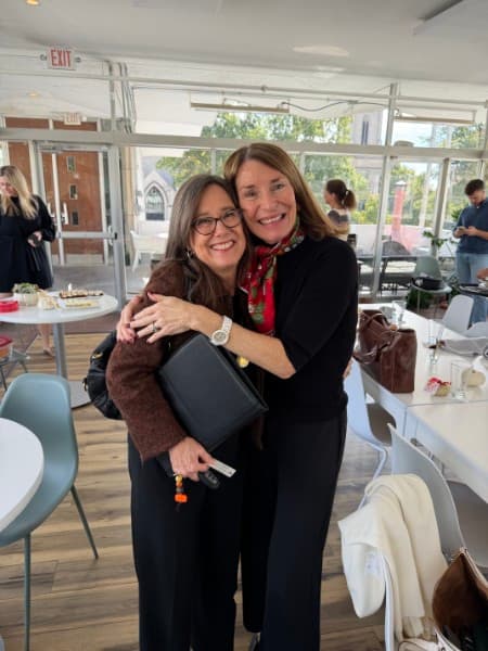 Nancy Moore hugging a guest at The Vault